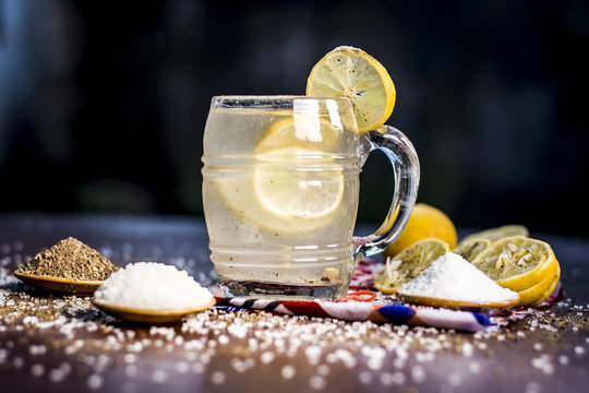 Close up of Indian most popular summer drink Nimbu pani or Nimbo sarbat,Lemonade in a transparent glass with salt and black pepper.