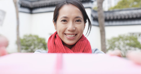 Happy woman receiving a gift box in china