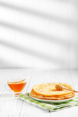 Delicious pancakes with honey on the table. The concept of food, breakfast,  pancake week.