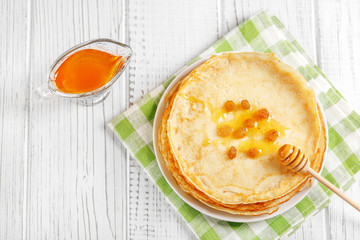 Traditional Ukrainian or Russian pancakes with honey and raisins. The concept of food, breakfast,  pancake week.