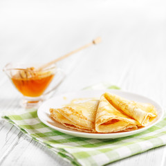 Delicious sweet pancakes with honey on the table. Square.The concept of food, breakfast,  pancake week.