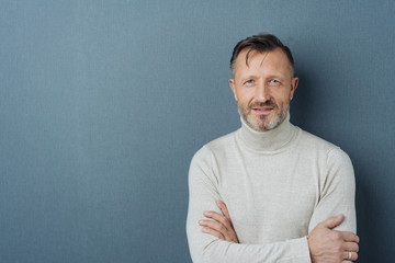 Friendly man with folded arms and copy space