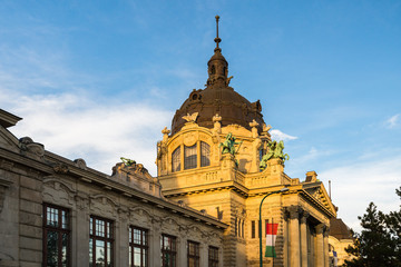 Main entrance to Szechenyi thermal bath lit by the evening sun in BudaPest, Hungary