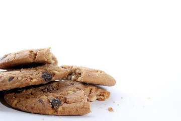 Chocolate chips and hazelnuts over white background