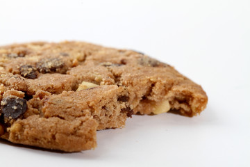 Chocolate chips and hazelnuts over white background