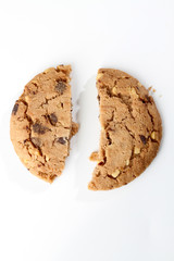 Chocolate chips and hazelnuts over white background