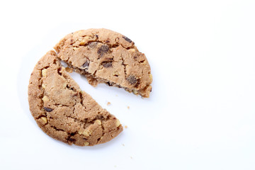 Chocolate chips and hazelnuts over white background