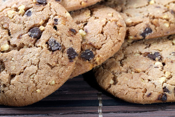 Chocolate chips and hazelnuts over white background