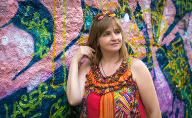 portrait of a young woman against a graffiti background