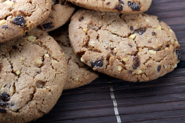 Chocolate chips and hazelnuts over white background