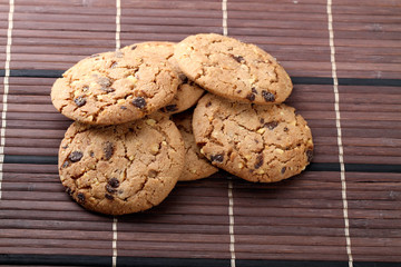 Chocolate chips and hazelnuts over white background