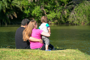 family sitting by the lake