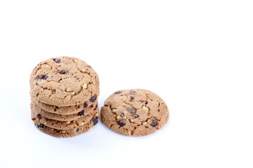 Chocolate chips and hazelnuts over white background