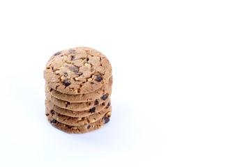 Chocolate chips and hazelnuts over white background