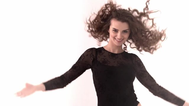 Portrait of the happy beautiful woman with brown long ringlets hair