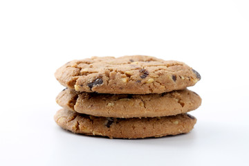 Chocolate chips and hazelnuts over white background