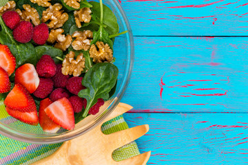 Fresh baby spinach salad with berries and walnuts