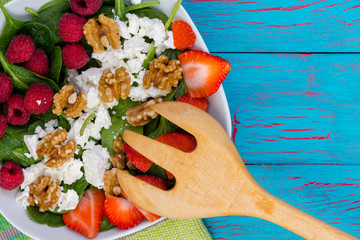 Healthy salad with fresh berries and feta cheese