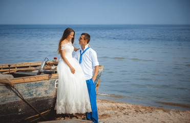 Wedding couple in a boat on the beach