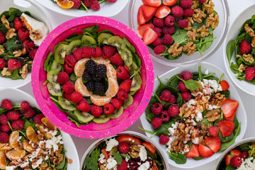 Conceptual above view of bowls of assorted fresh salads with fruit and nuts