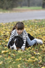 little girl play with dog in the park