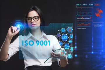 The concept of business, technology, the Internet and the network. A young entrepreneur working on a virtual screen of the future and sees the inscription: ISO 9001