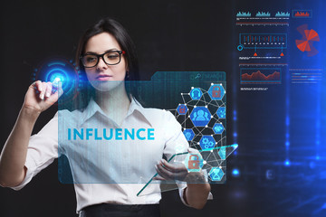 The concept of business, technology, the Internet and the network. A young entrepreneur working on a virtual screen of the future and sees the inscription: Influence