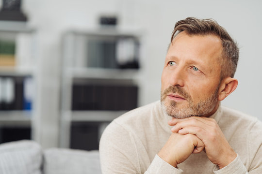 Middle-aged man sitting daydreaming
