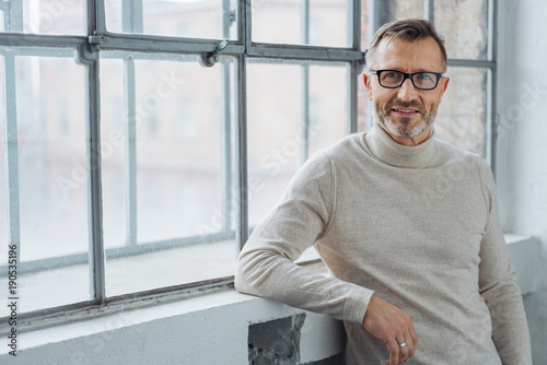 Smiling attractive mature man wearing glasses