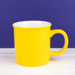 yellow cup with purple backround