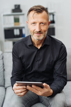Portrait of a confident man holding a tablet PC
