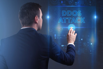 Business, Technology, Internet and network concept. Young businessman working on a virtual screen of the future and sees the inscription: Ddos attack