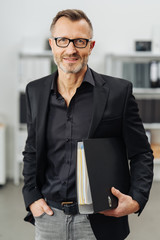Successful businessman carrying an office binder