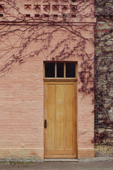 Rosa Hausfassade mit Holztür