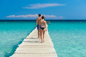 Wooden jetty with a young couple at the Mediterranean - 4070