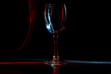 A glass of wine or goblet in night club. The light effect.
