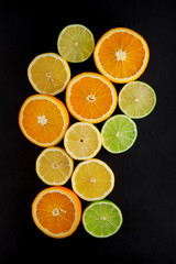 freshly sliced oranges, lemons and limes decorated on a slate plate can be used as a background