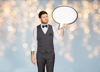 man in suit holding blank text bubble banner