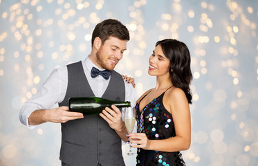 happy couple with champagne and glass at party