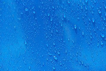 Rain drops on blue metal background