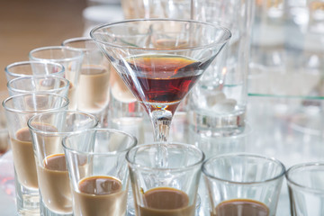 Alcoholic cocktails on a glass surface, banquet table.