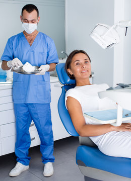 Girl is sitting satisfied after treatment in dental office