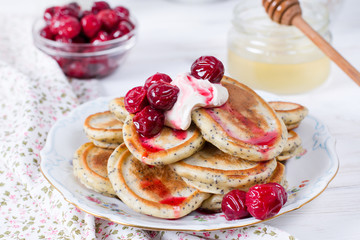Breakfast. Fritters with sour cream and fresh berries. Pancakes.