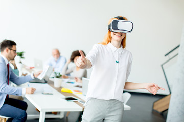 Young woman using virtual reality simulator in the office