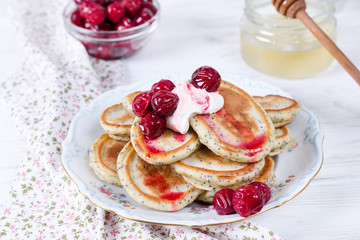 Breakfast. Fritters with sour cream and fresh berries. Pancakes.
