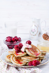 Homemade stack of pancakes with cherries for tasty healthy breakfast