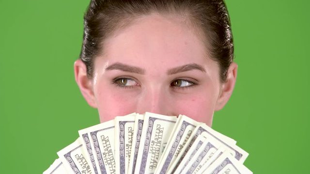 Winner Holds A Lot Of Money In Her Hands. Green Screen. Close Up