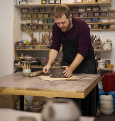 Skilled master preparing clay workpieces for new his creations