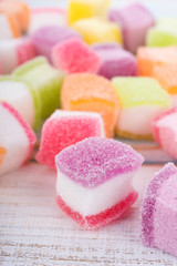 closeup colorful candy and jelly sweet on wooden