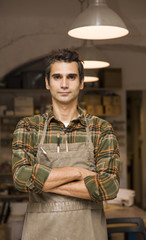 Fototapeta premium Handsome young man posing in pottery workshop
